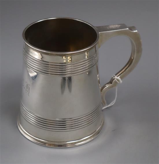 A George V silver mug with reeded bands, by Elkington & Co, Birmingham, 1913, 11 oz.